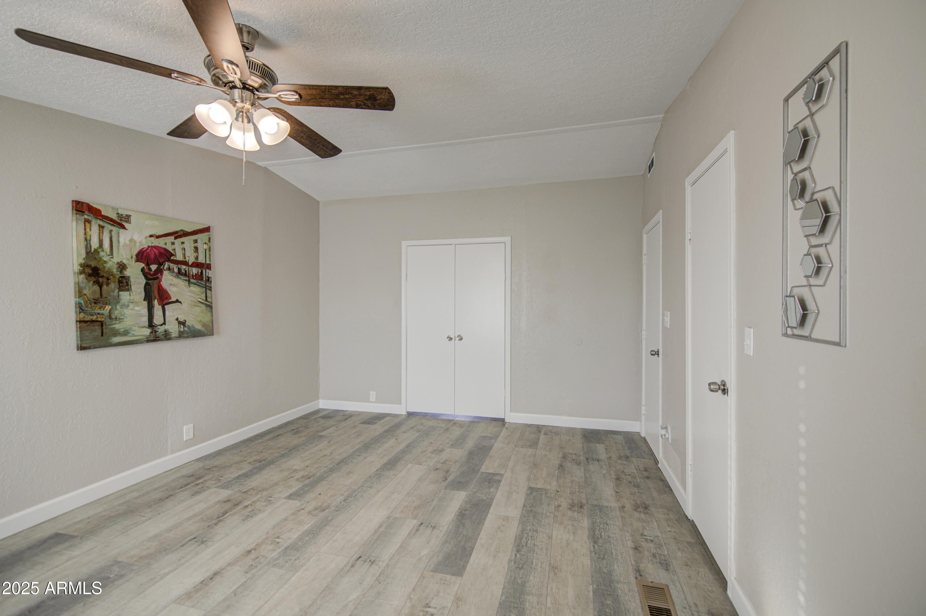 19954 West Teepee Road Buckeye, AZ 85326 - Photo 26 of 46 a view of a hallway with a chandelier fan