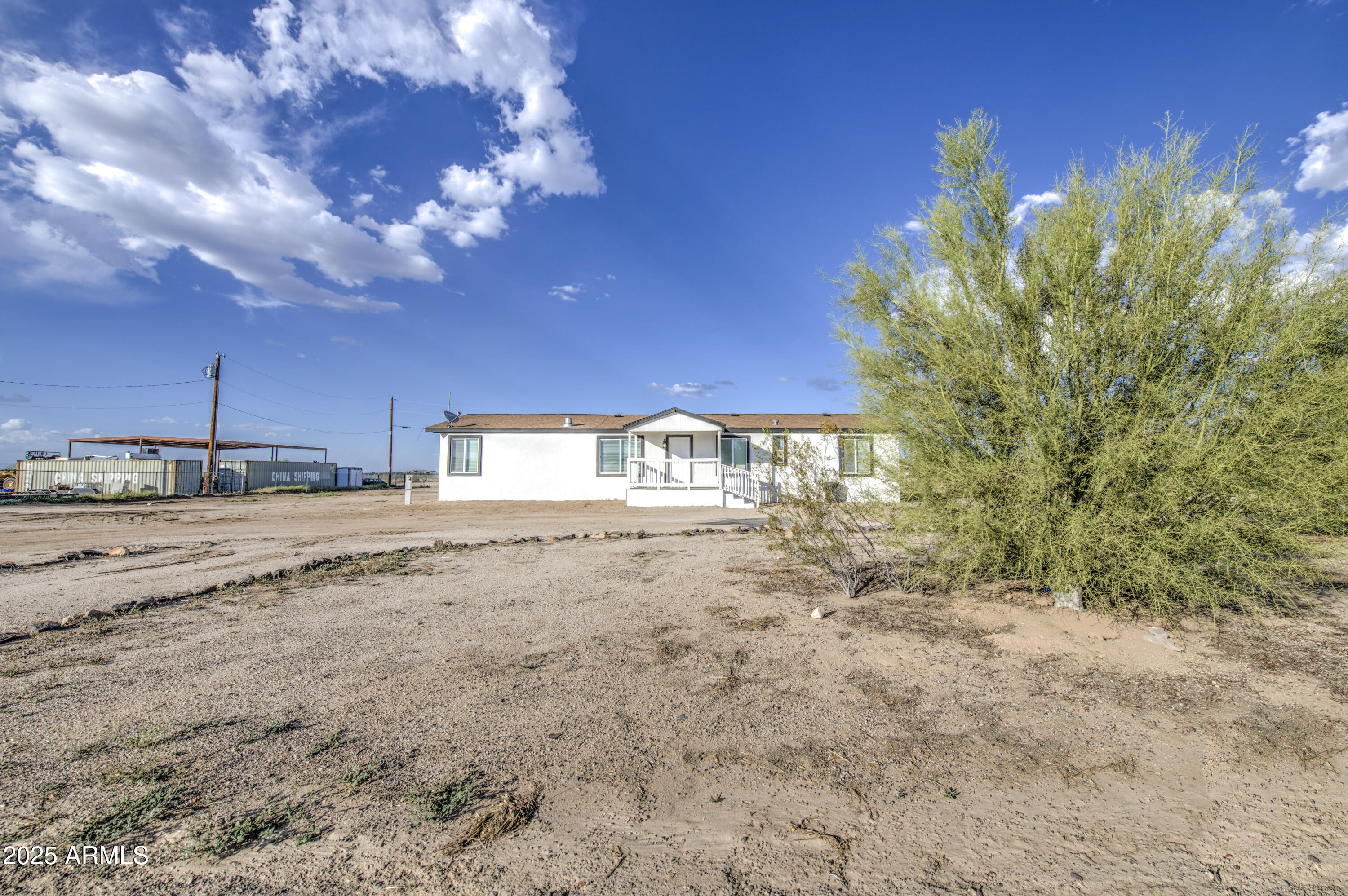 19954 West Teepee Road Buckeye, AZ 85326 - Photo 6 of 46 a view of a dry yard with wooden fence