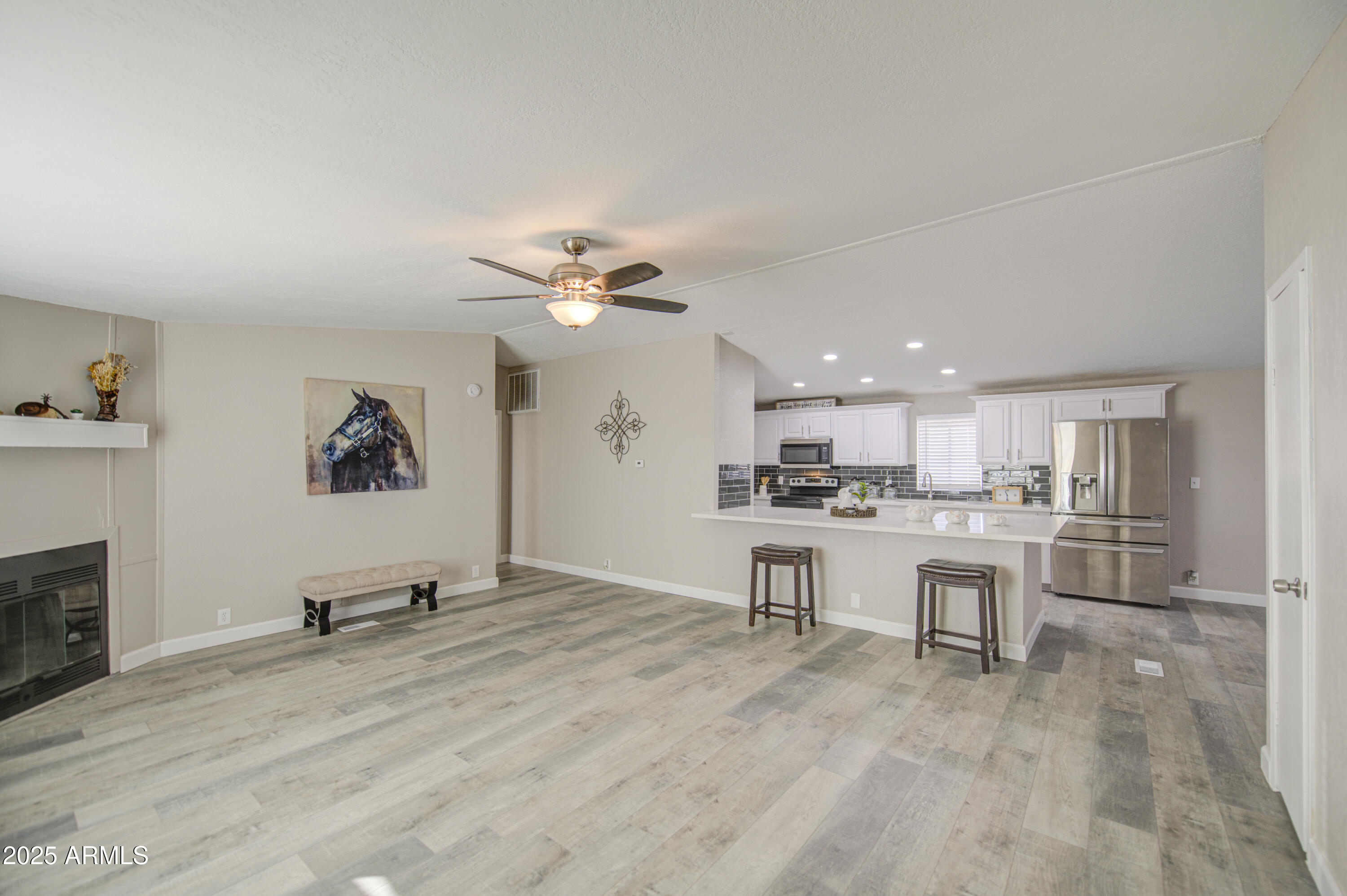 19954 West Teepee Road Buckeye, AZ 85326 - Photo 8 of 46 a view of a work space with furniture and a kitchen view