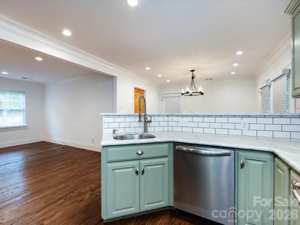 a kitchen with sink and cabinets