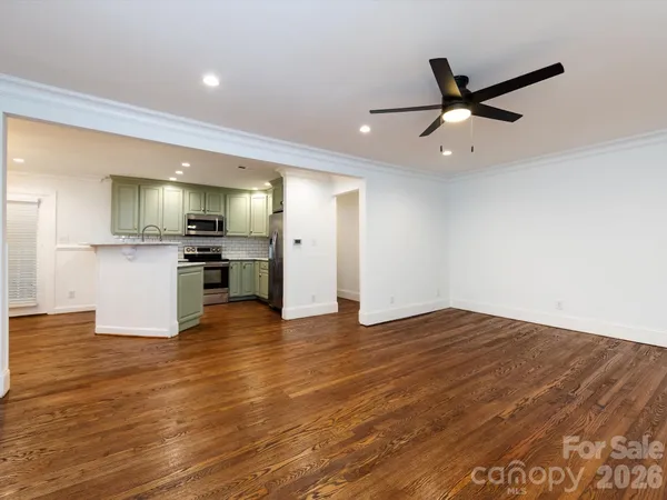 a view of a kitchen with a sink and a refrigerator