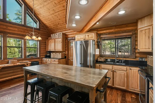 a kitchen with stainless steel appliances a refrigerator and a stove top oven