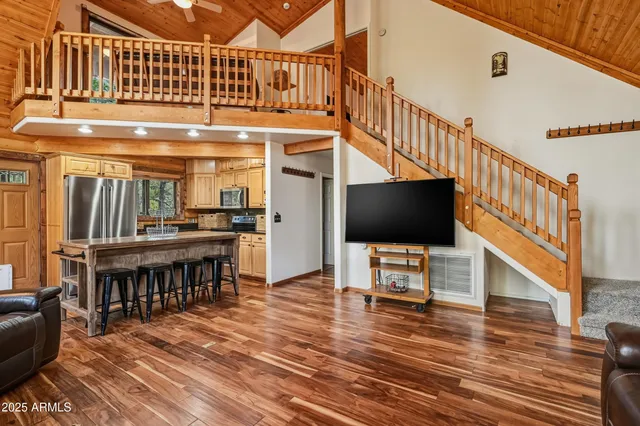a kitchen with stainless steel appliances and wooden floor