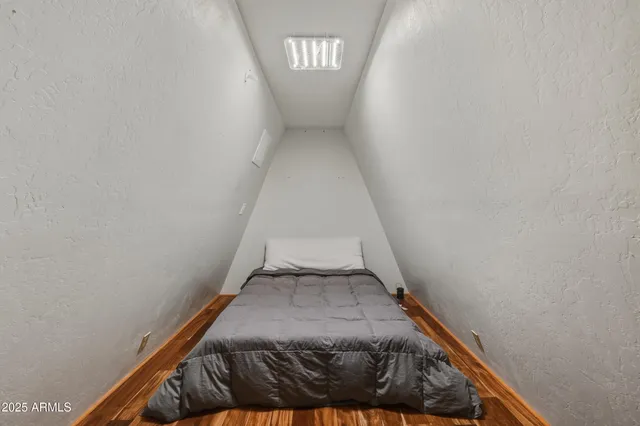 a bedroom with a bed and a television