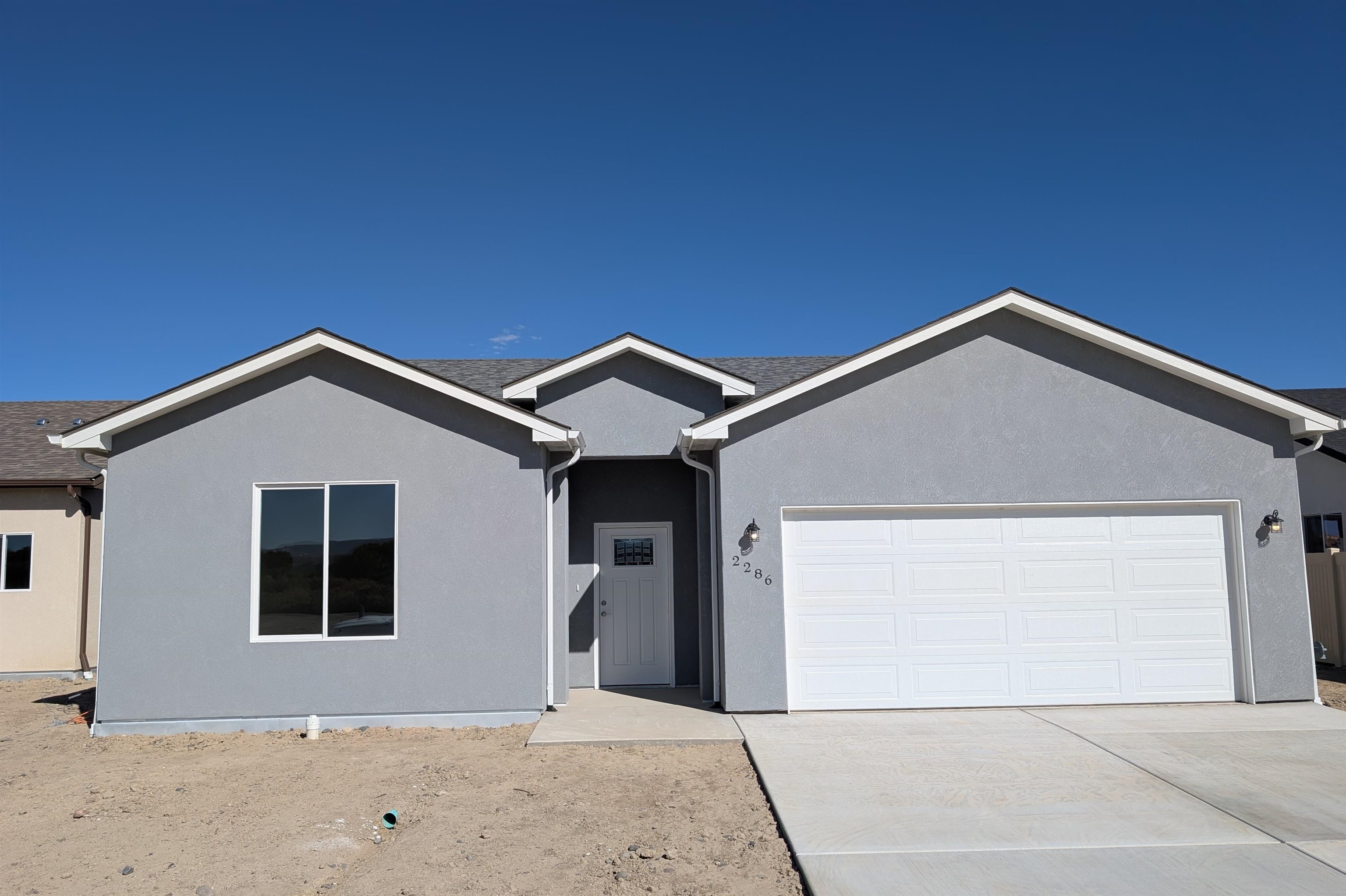 a front view of a house with garage