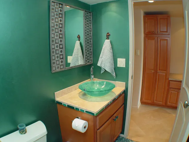 a bathroom with a sink a toilet and a mirror