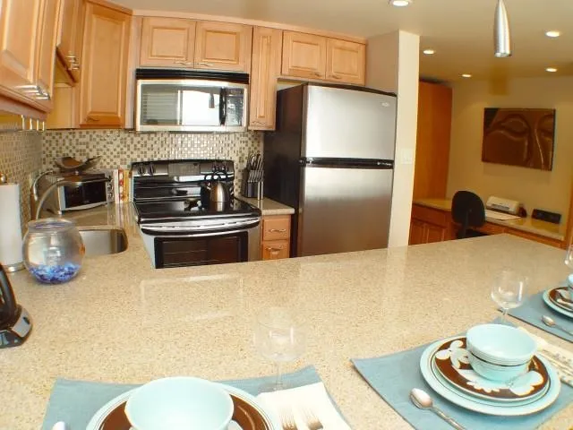 a kitchen with stainless steel appliances a refrigerator and a stove