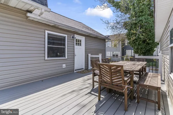a backyard of a house with a garden and barbeque oven