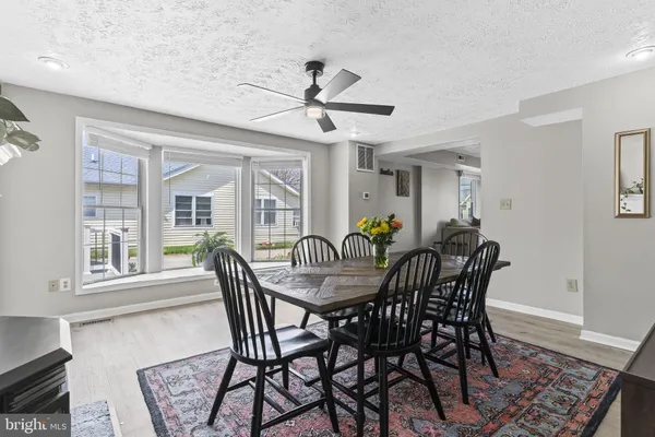 a view of a dining room with furniture and a fireplace