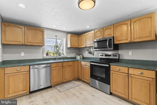 a kitchen with a refrigerator and a sink