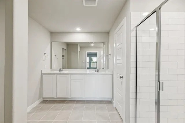 a bathroom with a mirror and a shower