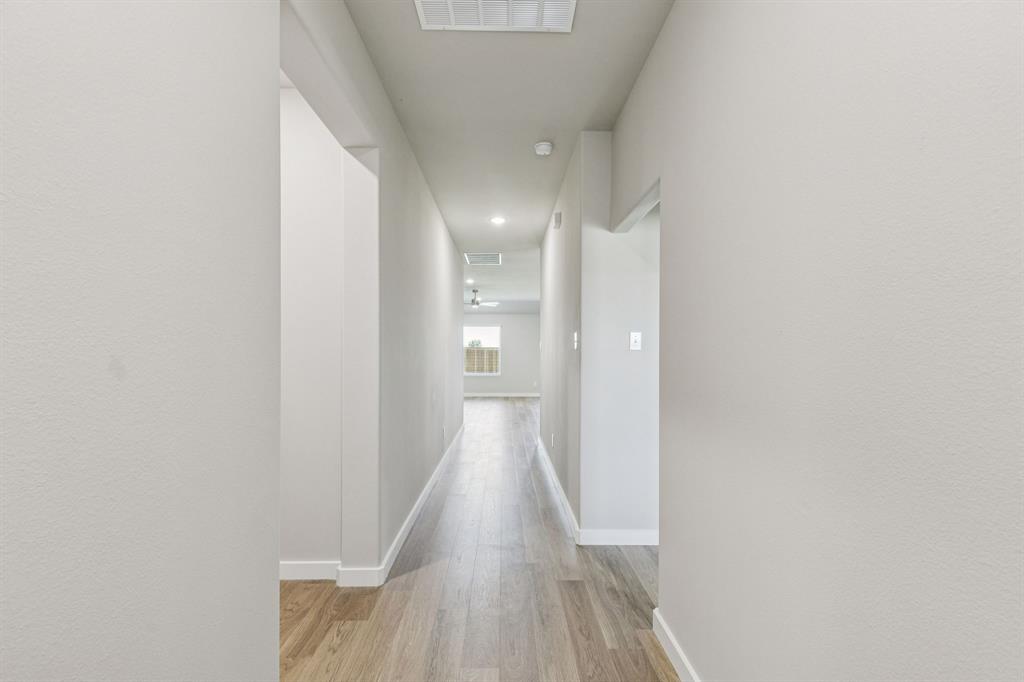 697 Poppy Lane Lavon, TX 75166 - Photo 4 of 27 a view of a hallway with wooden floor