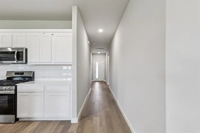 a view of a kitchen with electric appliances
