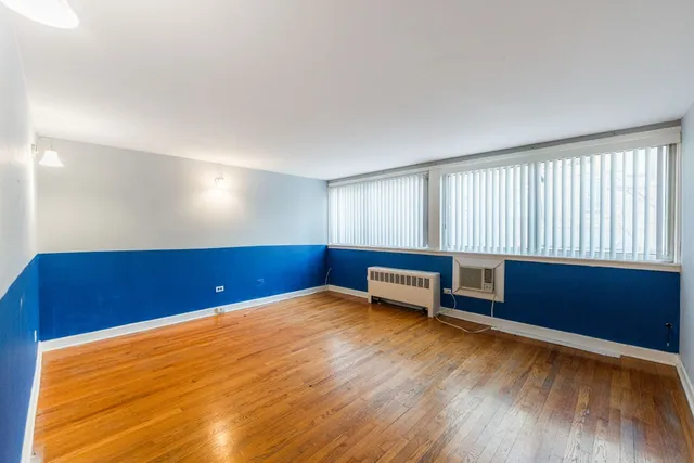 a view of a room with furniture wooden floor and window