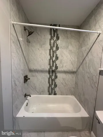 a bathroom with a shower and a bathtub