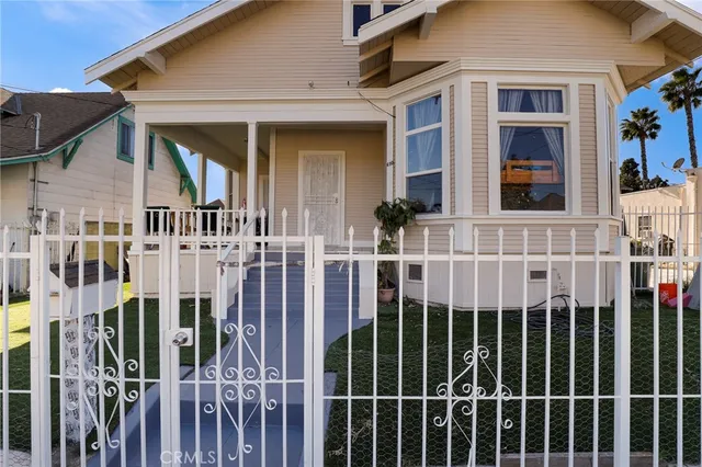 a view of a brick house with many windows