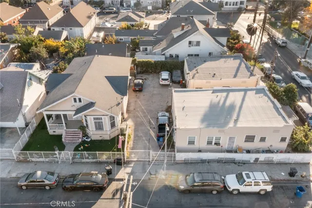 an aerial view of a house with car parked