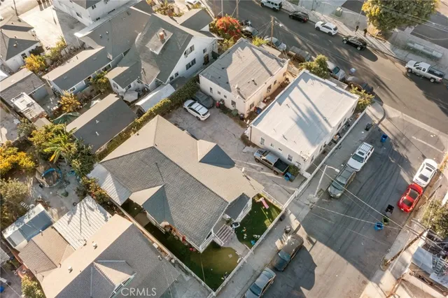an aerial view of a residential apartment building with a yard