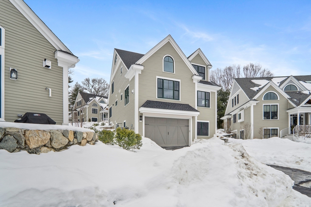 17 Courtyard Place, Unit 17 Reading, MA 01867 - Photo 2 of 12 a front view of a house with a yard
