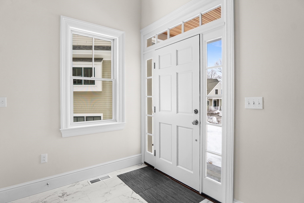 17 Courtyard Place, Unit 17 Reading, MA 01867 - Photo 4 of 12 an entryway to room with wooden floor and windows