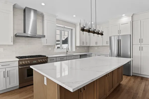 a kitchen with a stove a sink and a refrigerator