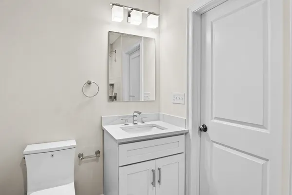 a bathroom with a sink vanity and a mirror