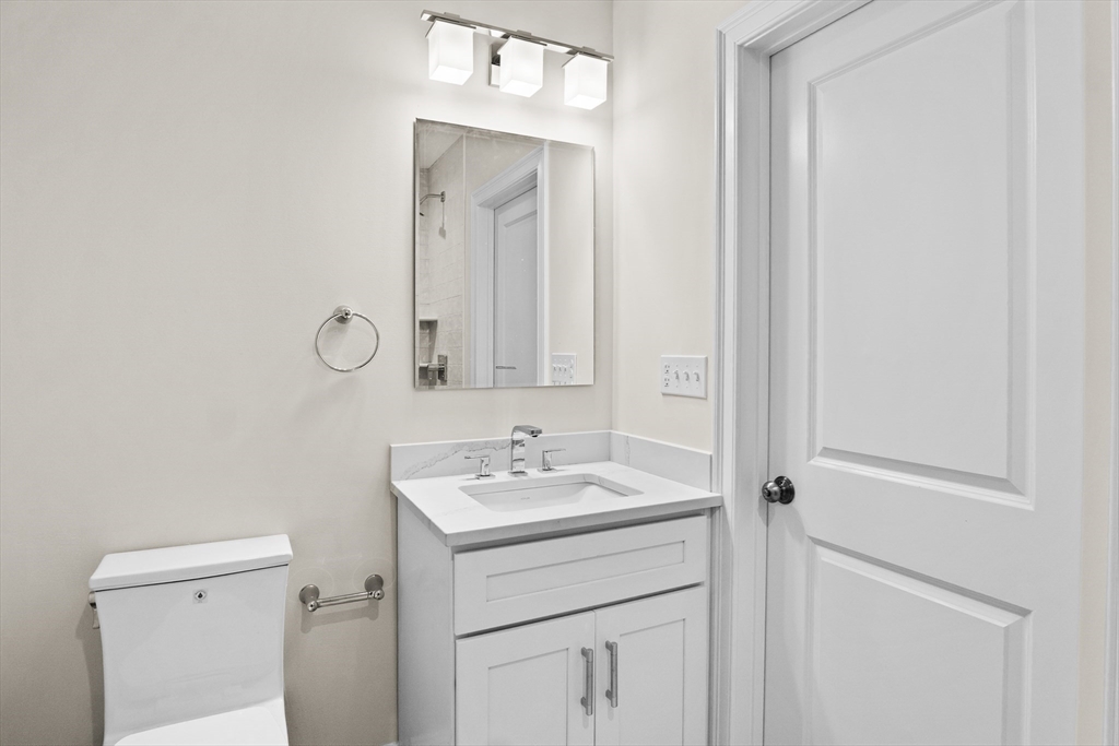 17 Courtyard Place, Unit 17 Reading, MA 01867 - Photo 8 of 12 a bathroom with a sink vanity and a mirror