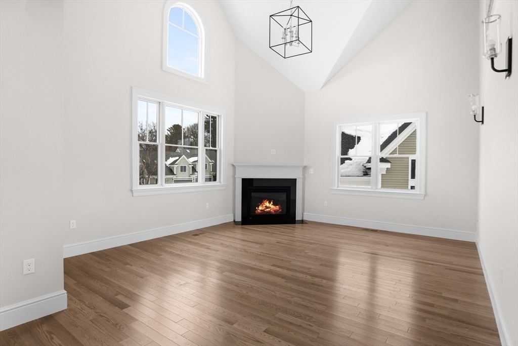 17 Courtyard Place, Unit 17 Reading, MA 01867 - Photo 9 of 12 a view of an empty room with wooden floor and a window