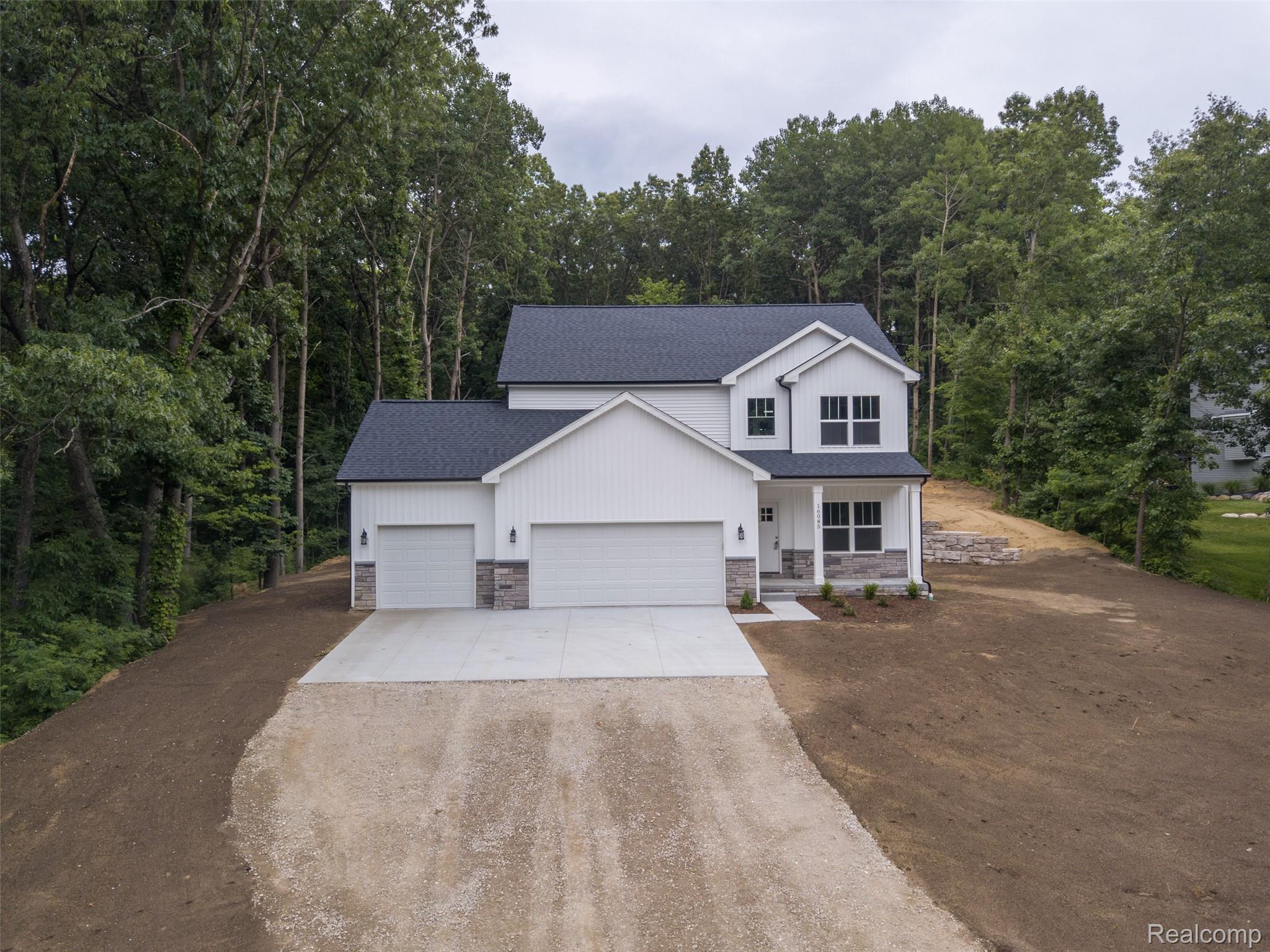 Contemporary two-story residence with a dark shingle roof and white siding