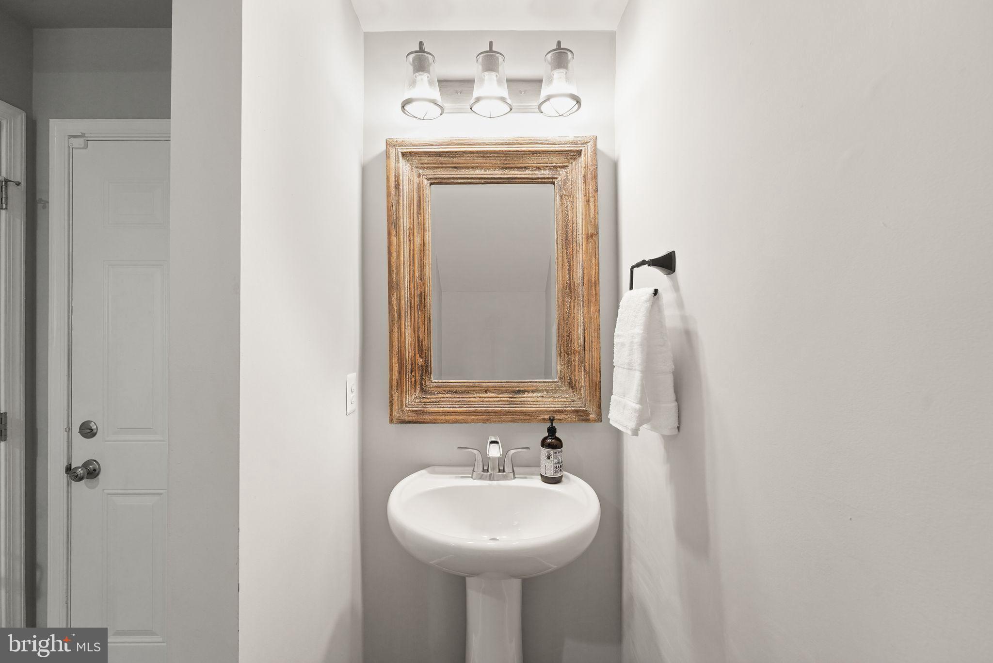 43846 Artsmith Terrace Ashburn, VA 20147 - Photo 14 of 38 a bathroom with a sink and a mirror
