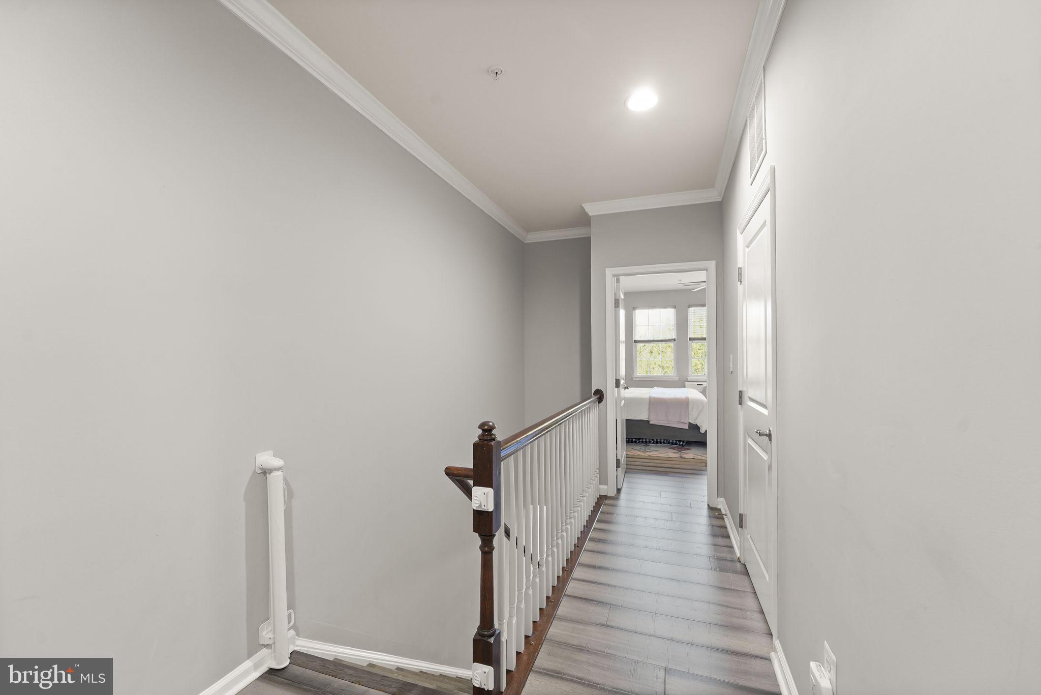 43846 Artsmith Terrace Ashburn, VA 20147 - Photo 16 of 38 a view of a hallway with wooden floor and staircase