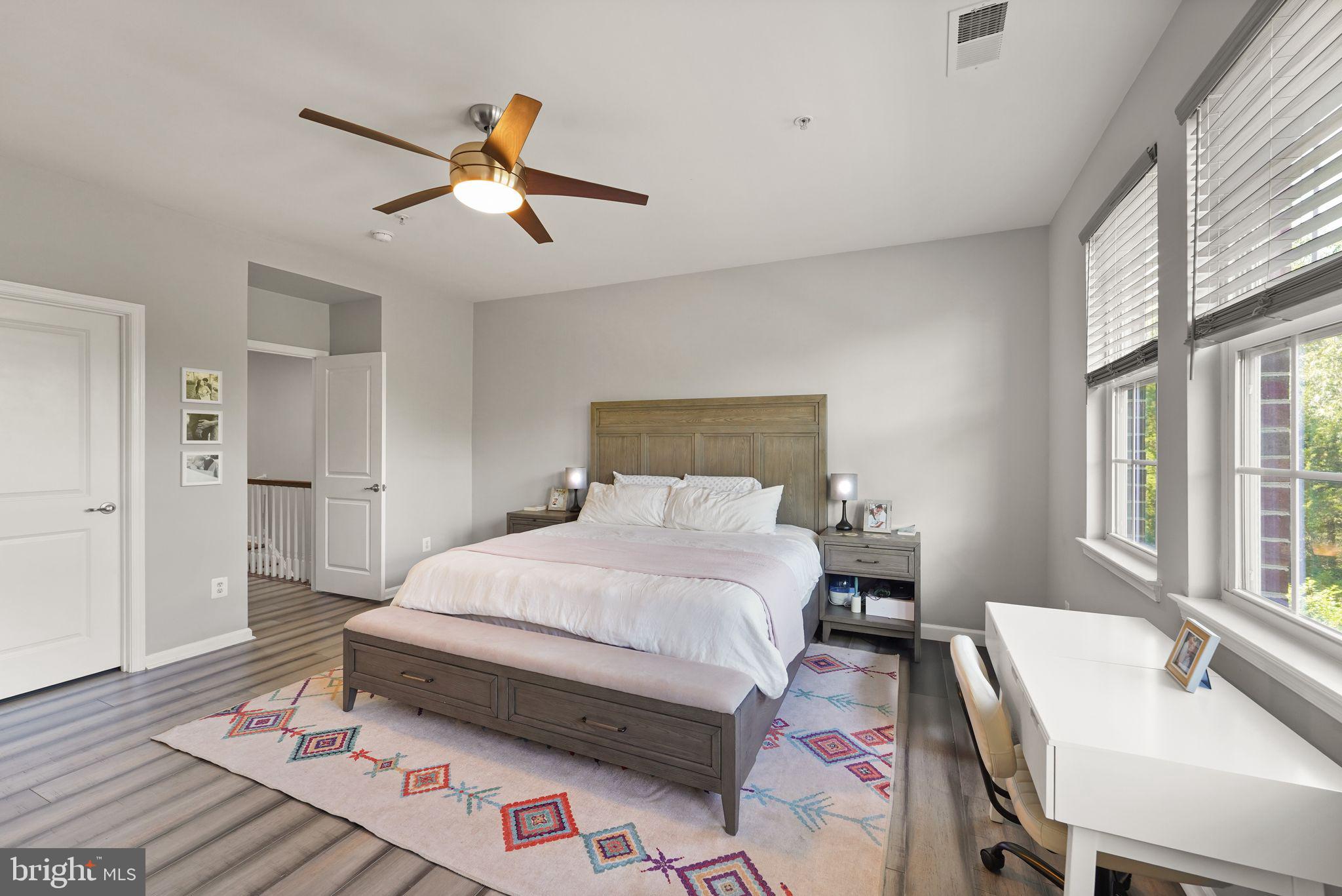 43846 Artsmith Terrace Ashburn, VA 20147 - Photo 19 of 38 a bedroom with a bed and wooden floor