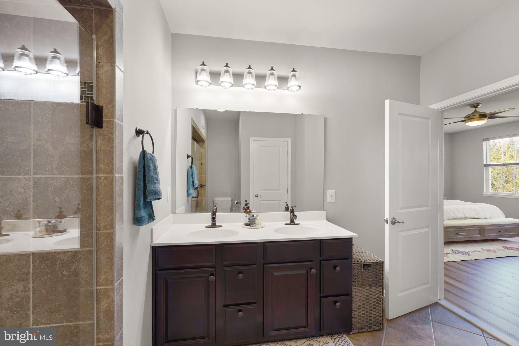 43846 Artsmith Terrace Ashburn, VA 20147 - Photo 21 of 38 a bathroom with a sink vanity and mirror