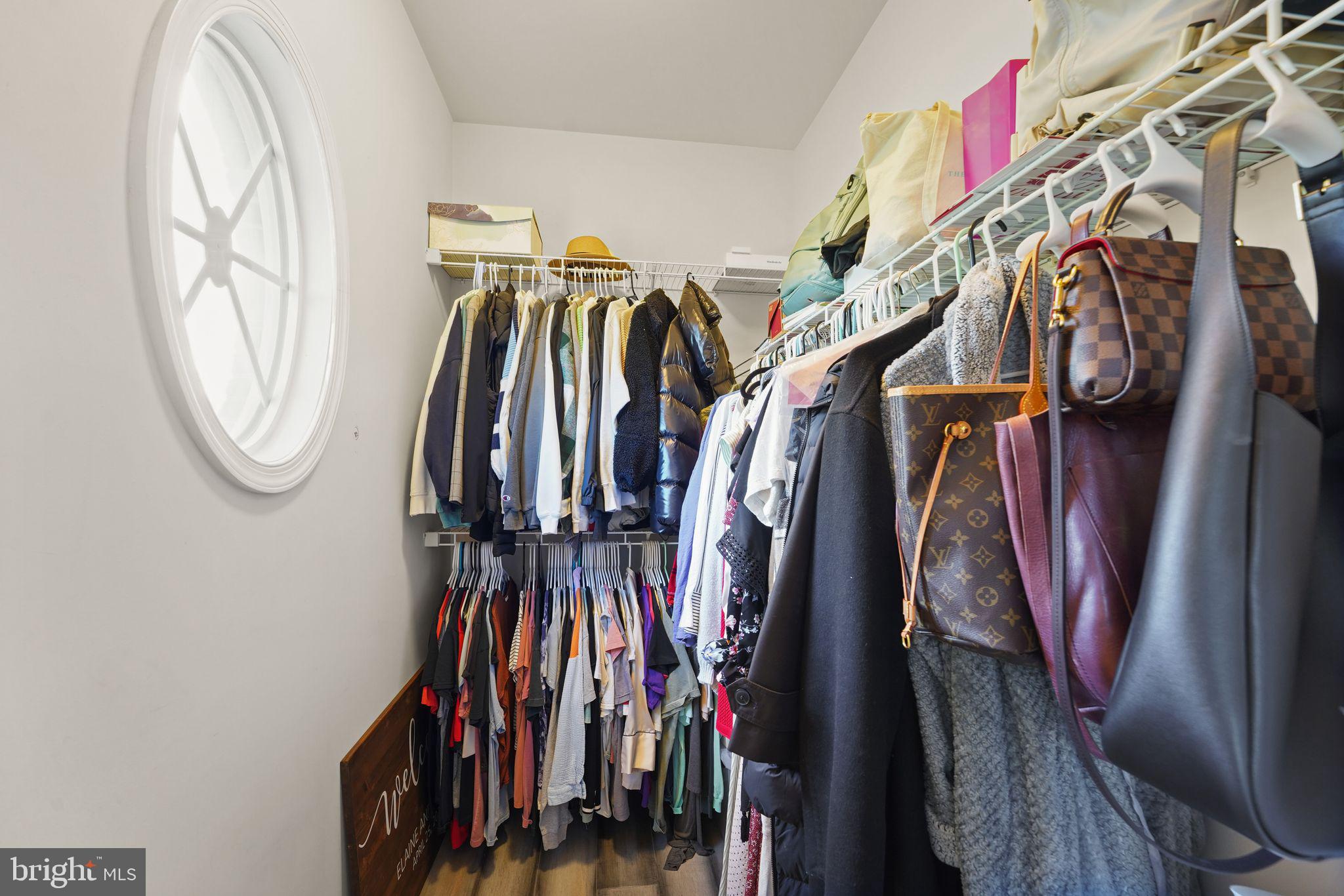 43846 Artsmith Terrace Ashburn, VA 20147 - Photo 23 of 38 a view of walk in closet with clothes and shoes