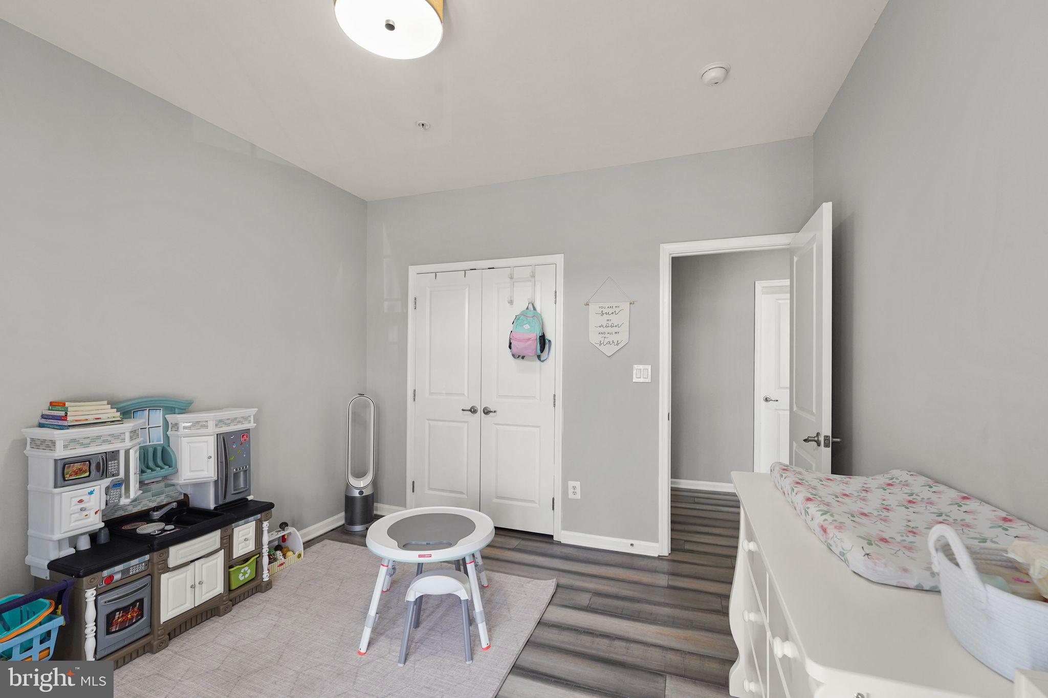 43846 Artsmith Terrace Ashburn, VA 20147 - Photo 27 of 38 a bedroom with a bed and a flat screen tv