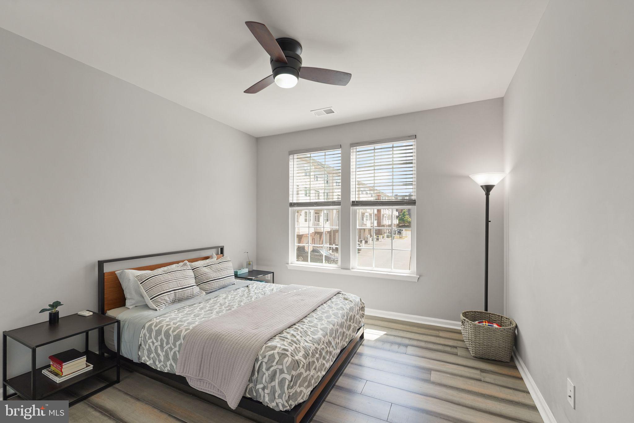 43846 Artsmith Terrace Ashburn, VA 20147 - Photo 30 of 38 a bedroom with a bed and wooden floor