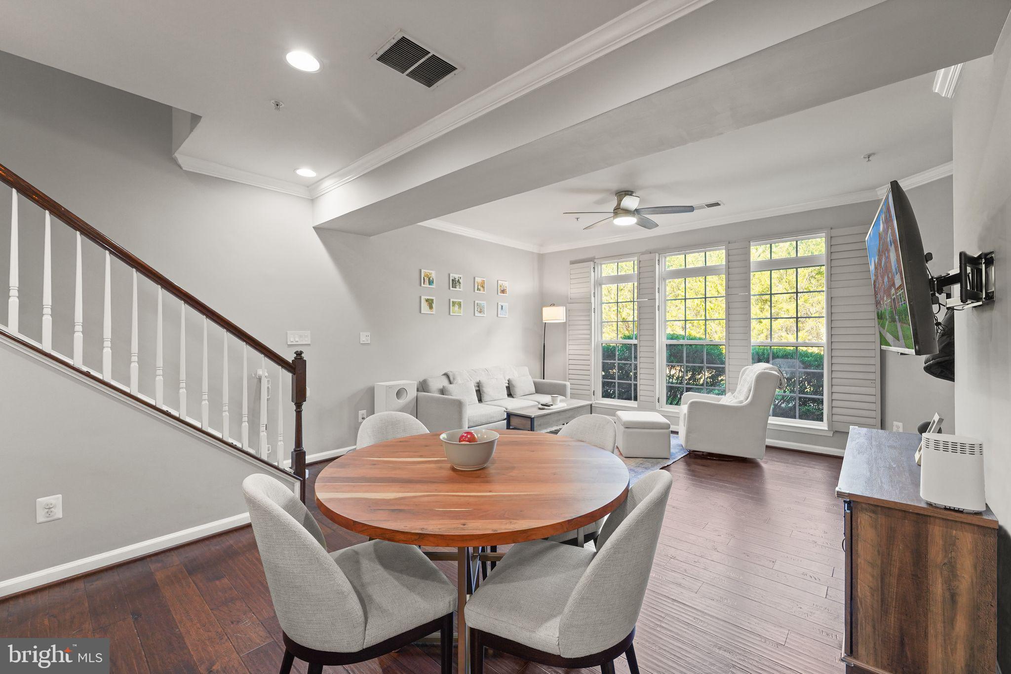 43846 Artsmith Terrace Ashburn, VA 20147 - Photo 8 of 38 a dining room with furniture a rug and wooden floor