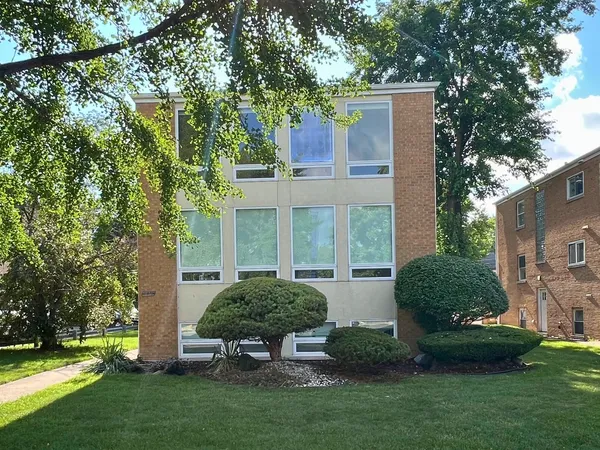 a view of a house with backyard sitting area and garden
