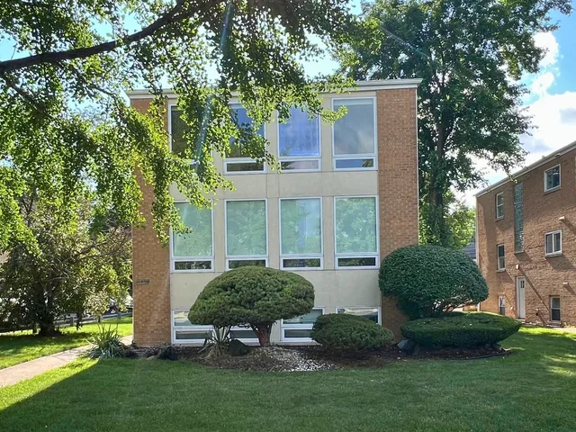a view of a house with backyard sitting area and garden