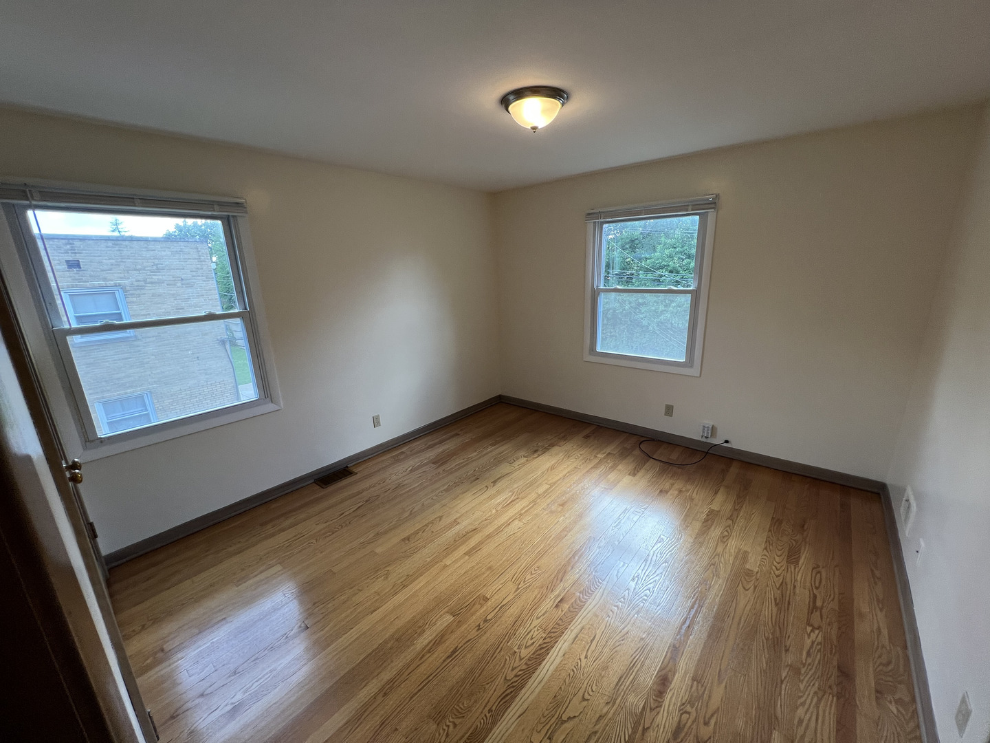 3014 Harlem Avenue, Unit 1 Riverside, IL 60546 - Photo 17 of 22 an empty room with wooden floor and windows