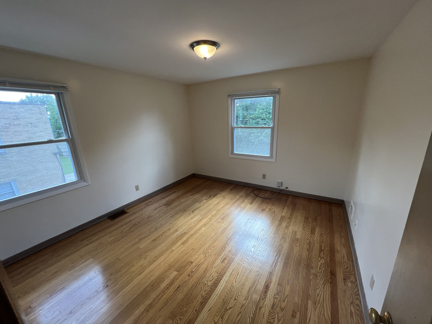 3014 Harlem Avenue, Unit 1 Riverside, IL 60546 - Photo 8 of 22 a view of an empty room with wooden floor and a window
