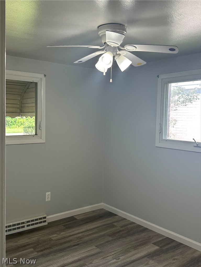1001 Keefer Road Girard, OH 44420 - Photo 17 of 42 Spare room with a wealth of natural light, ceiling fan, and dark wood-type flooring