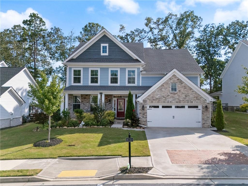 8110 Scenic Ridge Way Ball Ground, GA 30107 - Photo 1 of 29 a front view of a house with a yard and garage