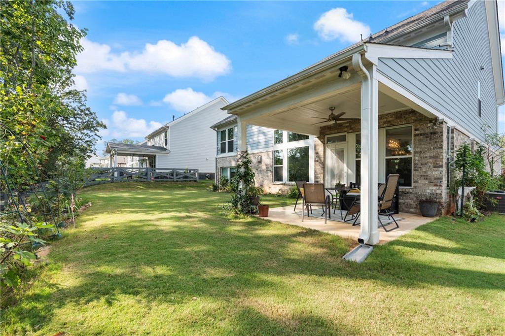 8110 Scenic Ridge Way Ball Ground, GA 30107 - Photo 12 of 29 a view of a house with a yard patio and swimming pool