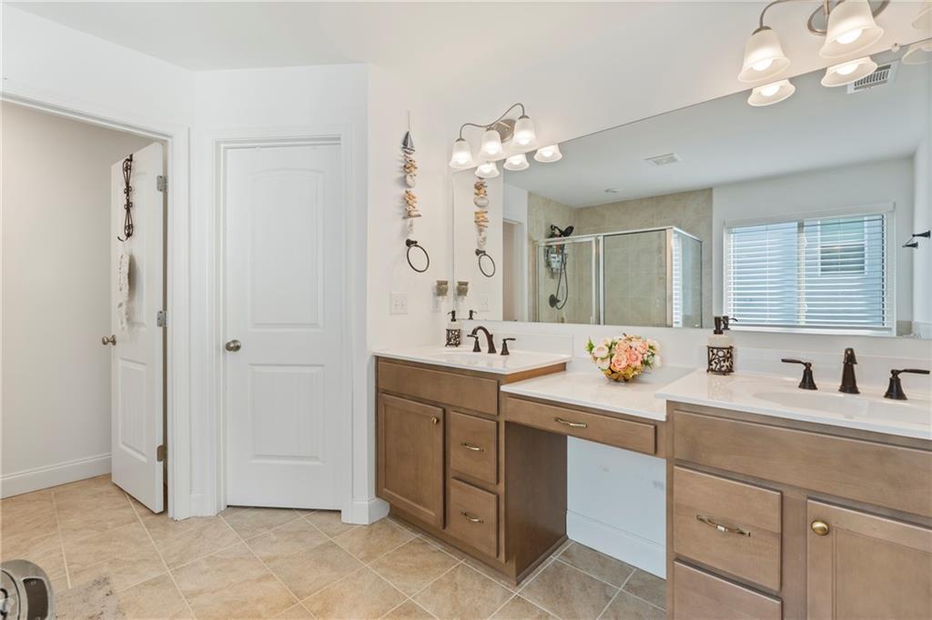 8110 Scenic Ridge Way Ball Ground, GA 30107 - Photo 15 of 29 a bathroom with a sink vanity and mirror