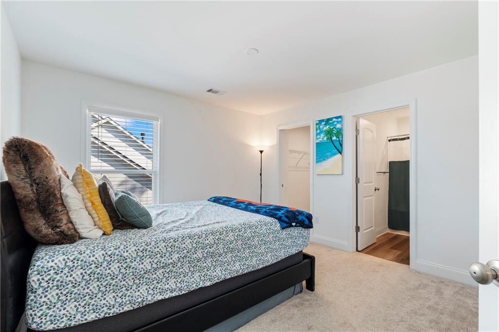 8110 Scenic Ridge Way Ball Ground, GA 30107 - Photo 16 of 29 a bedroom with a bed and wooden floor