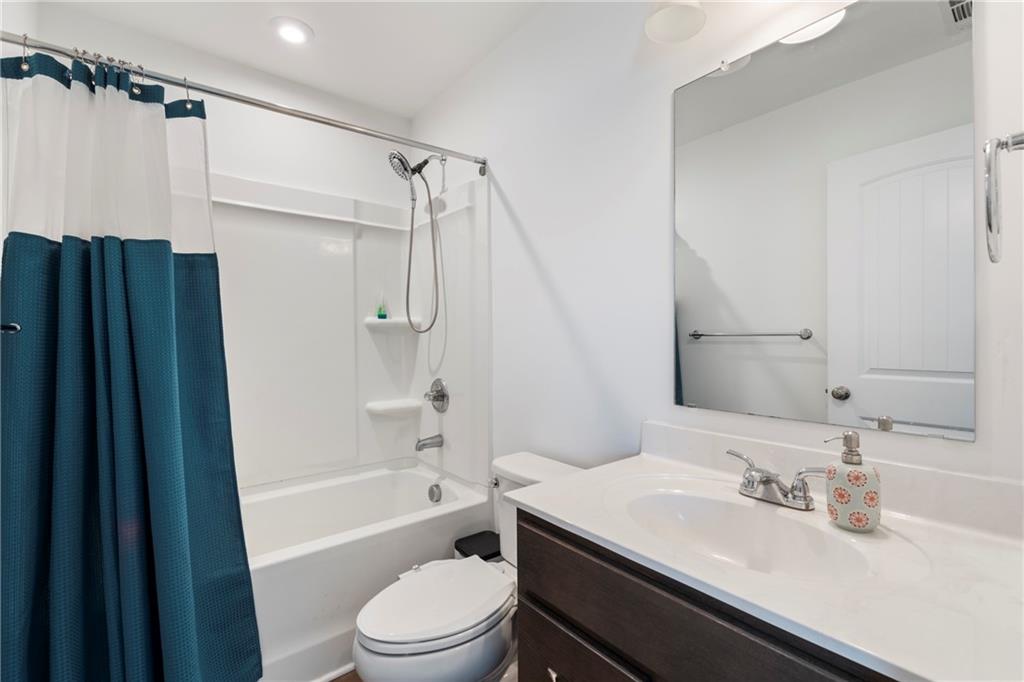 8110 Scenic Ridge Way Ball Ground, GA 30107 - Photo 17 of 29 a bathroom with a granite countertop sink toilet and shower