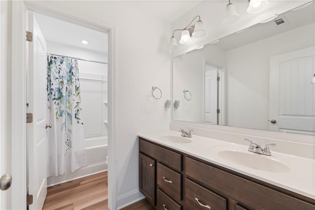8110 Scenic Ridge Way Ball Ground, GA 30107 - Photo 18 of 29 a bathroom with a double vanity sink mirror and shower