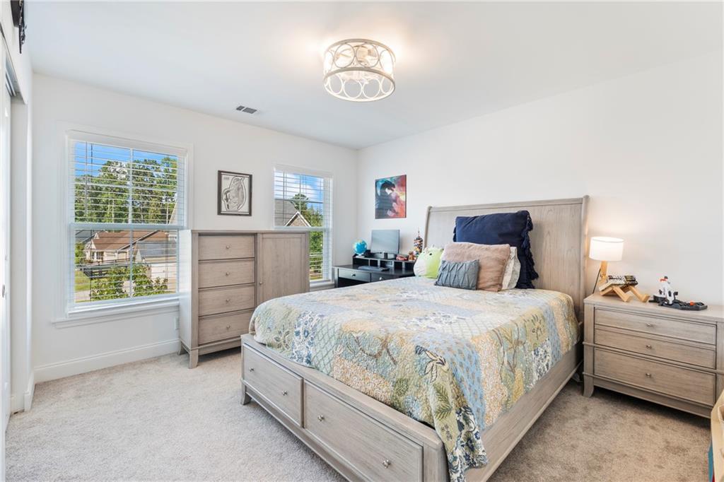 8110 Scenic Ridge Way Ball Ground, GA 30107 - Photo 19 of 29 a bedroom with bed and window