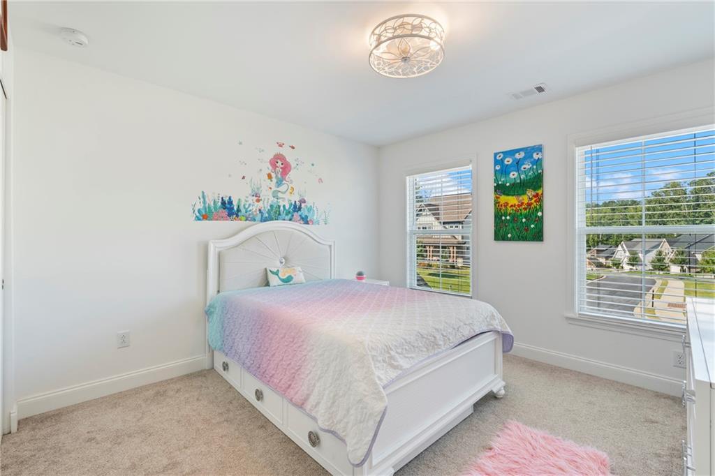 8110 Scenic Ridge Way Ball Ground, GA 30107 - Photo 20 of 29 a bedroom with a bed and a window